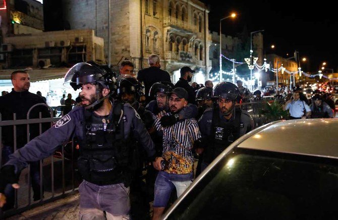 Israeli policemen arrest a Palestinian protester near the Damascus Gate in Jerusalem’s Old City, on April 25, 2021. (AFP)