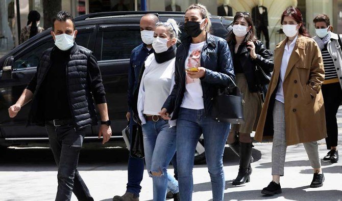 People wearing masks to help protect against the spread of coronavirus, walk along a street before a daily lockdown, in Ankara, Turkey, Tuesday, April 27, 2021. (AP)