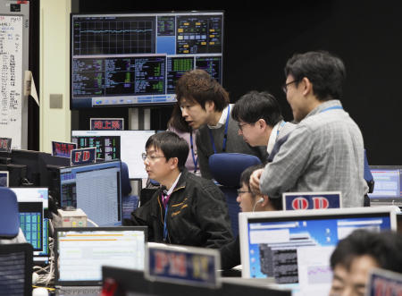 In this Feb. 21, 2019, file photo provided by JAXA, staff of Hayabusa2 Project watch monitors for a safety check at the control room of the JAXA Institute of Space and Astronautical Science in Sagamihara, near Tokyo. (AP)