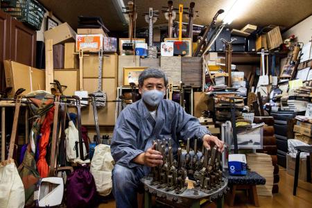 In this picture taken on April 12, 2021, Kimiaki Kono, who created a special Tokyo 2020 branded shamisen, poses at his workshop in Tokyo. (AFP)