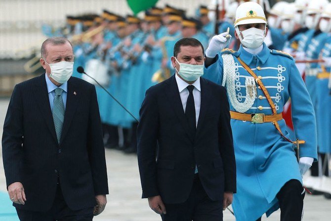 Turkish President Recep Tayyip Erdogan (left) and Libyan government of national unity prime minister Abdul Hamid Dbeibah (right) walk past honour guards during the official ceremony prior to their meeting in Ankara on April 12, 2021. (AFP/File Photo)