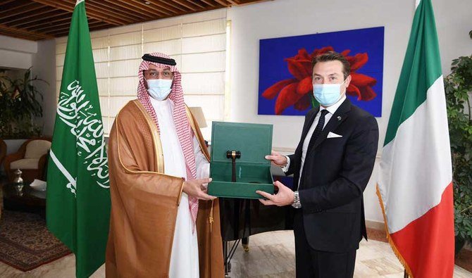 Saudi Arabia’s G20 Sherpa Abdul Aziz Al-Rasheed hands over the honorary gavel to Valerio De Parolis, charge d’ affaires at the Italian Embassy in Riyadh on Monday. (Supplied)