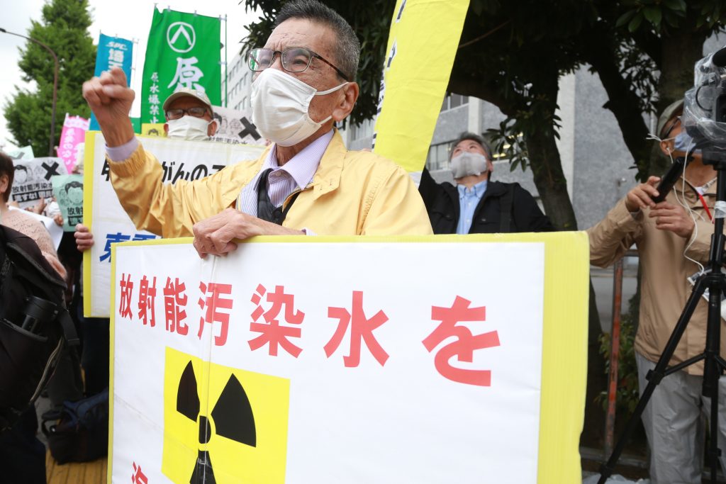 Demonstrators at the side walk of the Japanese Parliament and Prime Minister office carry signs denouncing and objecting the decision to release the radioactive water from Fukushima nuclear power station into the Pacific Ocean. (ANJ Photos)