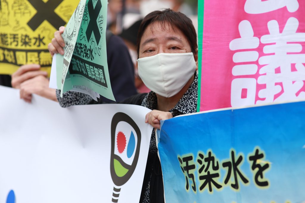 Demonstrators at the side walk of the Japanese Parliament and Prime Minister office carry signs denouncing and objecting the decision to release the radioactive water from Fukushima nuclear power station into the Pacific Ocean. (ANJ Photos)