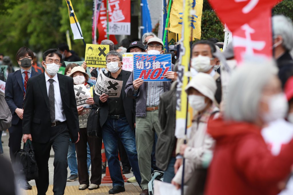 Demonstrators at the side walk of the Japanese Parliament and Prime Minister office carry signs denouncing and objecting the decision to release the radioactive water from Fukushima nuclear power station into the Pacific Ocean. (ANJ Photos)