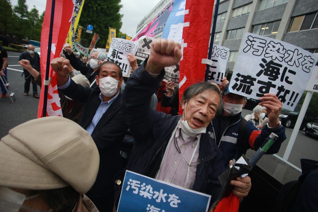 Demonstrators at the side walk of the Japanese Parliament and Prime Minister office carry signs denouncing and objecting the decision to release the radioactive water from Fukushima nuclear power station into the Pacific Ocean. (ANJ Photos)