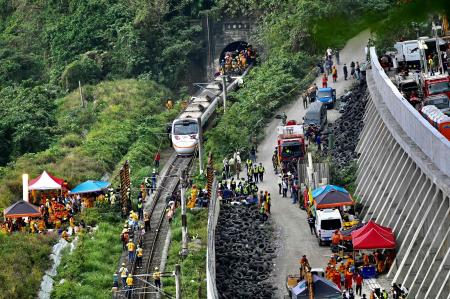 This photo shows rescue workers at the site where a train derailed inside a tunnel in the mountains of Hualien, eastern Taiwan on April 2, 2021. (AFP)