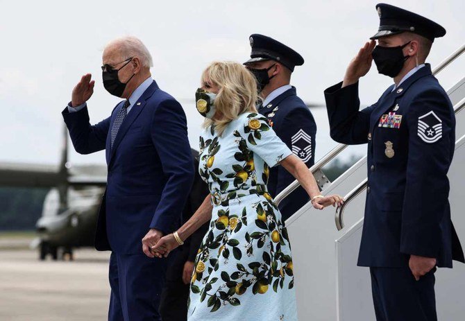 US President Joe Biden disembarks from Air Force One with first lady Jill Biden as he arrives in Georgia to promote plans to rebuild the US economy on April 29, 2021. (REUTERS)