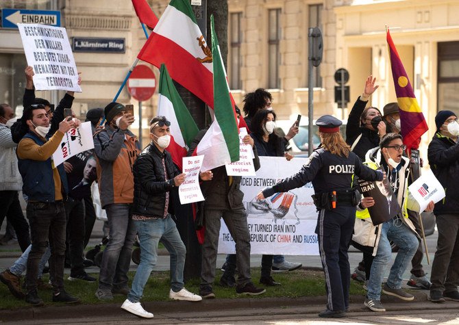 Activists of the National Council of Resistance of Iran, an Iranian opposition group, protest in front of the 'Grand Hotel Wien' in Vienna during the closed-door nuclear talks between Iran and the EU, China and Russia on April 9, 2021. (AFP / JOE KLAMAR)