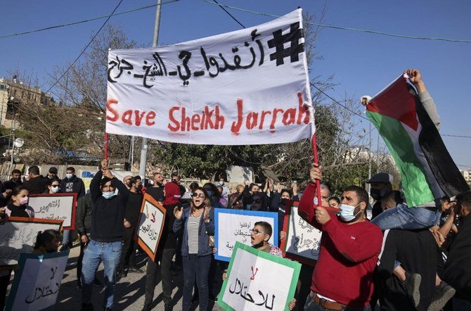 Activists protest the planned Israeli evictions in Sheikh Jarrah, Jerusalem, 19 March, 2021. (AFP)