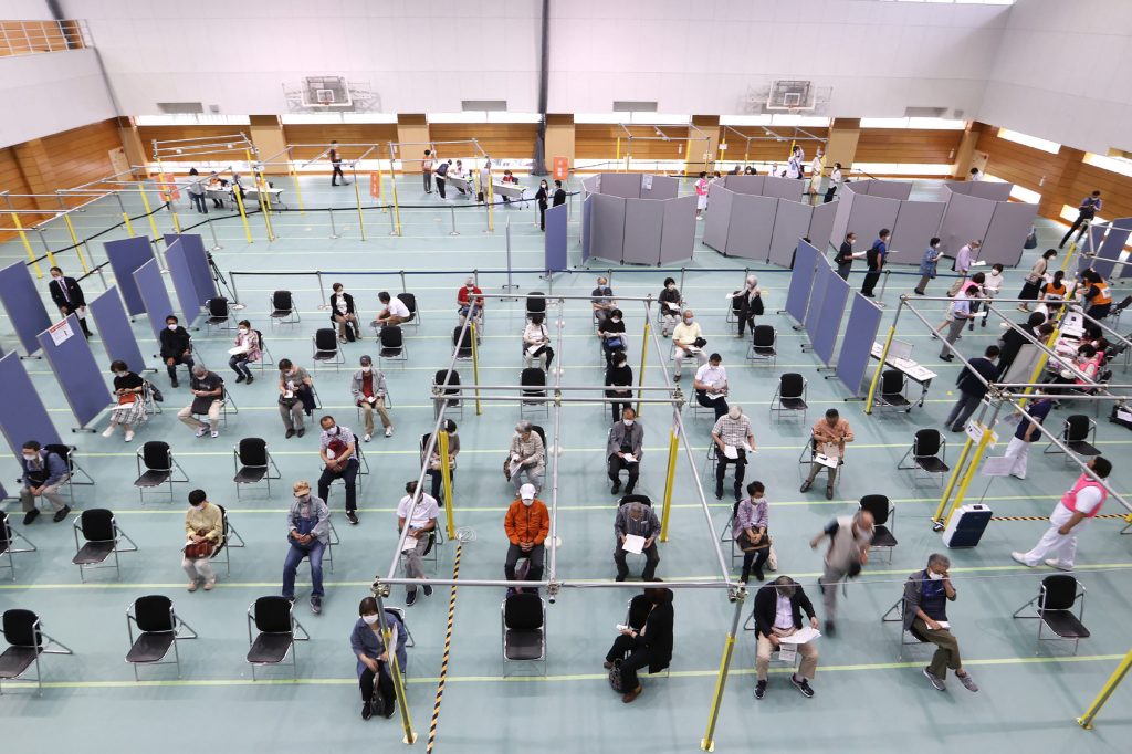 People gather to receive the Moderna coronavirus vaccine at a newly-opened mass vaccination centre in Toyoake City, Aichi prefecture on May 24, 2021. (AFP)