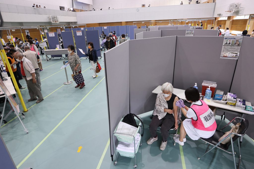 People gather to receive the Moderna coronavirus vaccine at a newly-opened mass vaccination centre in Toyoake City, Aichi prefecture on May 24, 2021. (AFP)