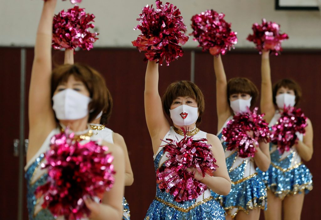 Fumie Takino, 89, founder of a senior cheer squad called Japan Pom Pom, and other Japan Pom Pom members, perform a dance routine while filming an online performance in Tokyo, Japan, April 12, 2021. (Reuters)