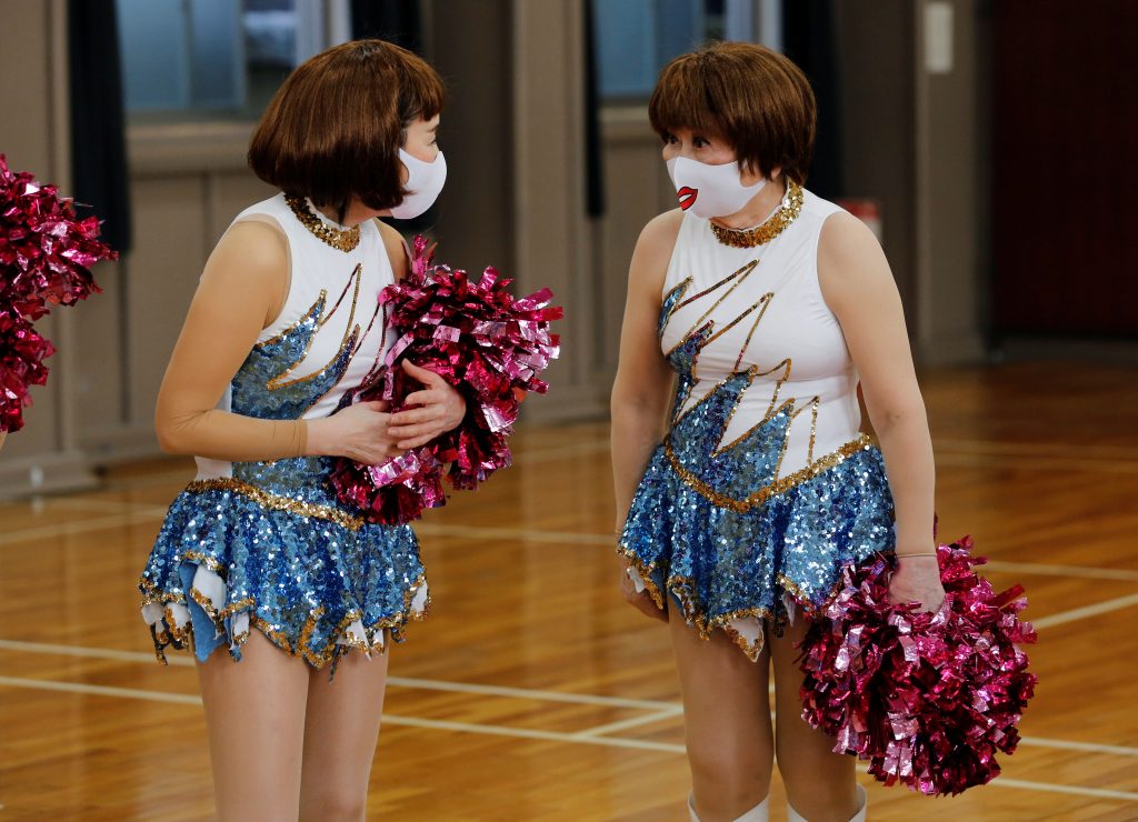 Fumie Takino, 89, founder of a senior cheer squad called Japan Pom Pom, talks to a member during a break from filming a dance routine for an online performance in Tokyo, Japan, April 12, 2021. (Reuters)