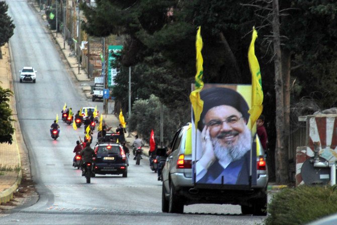 Supporters of the Shiite Hezbollah movement drive in a convoy in Kfar Kila on the Lebanese border with Israel on Oct. 25, 2019. (Photo by Ali Dia / AFP)