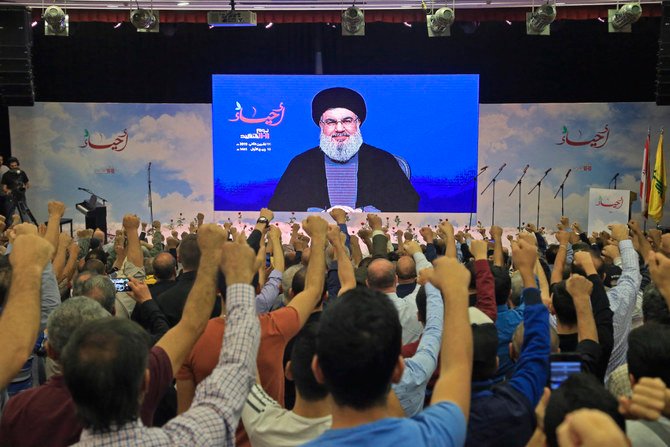 Lebanese Hezbollah Leader Hassan Nasrallah is cheered by his supporters as he speaks through a giant screen in Beirut's southern suburb. (AFP file photo)