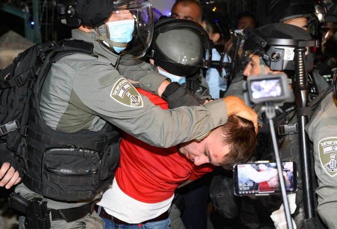 A Palestinian demonstrator is arrested by Israeli security forces in the in the Sheikh Jarrah neighborhood of occupied east Jerusalem on May 5, 2021. (AFP)