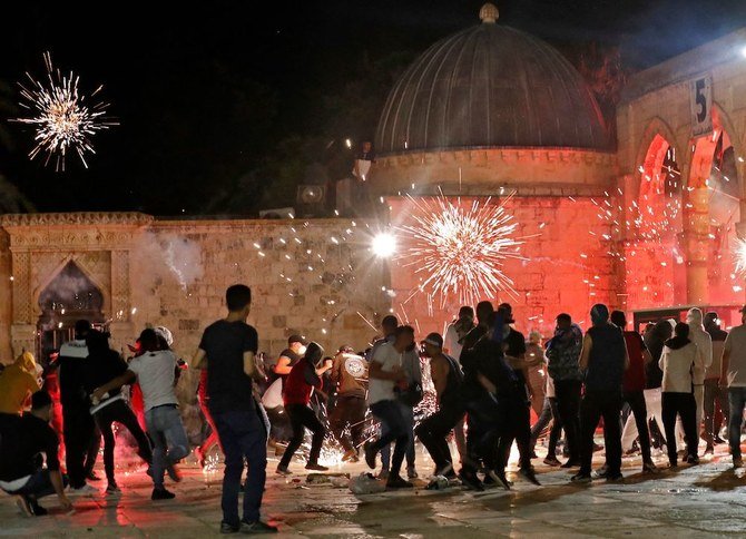 Stun grenades burst in the air amid clashes between Palestinian protesters and Israeli security forces at the Al-Aqsa mosque compound in Jerusalem. (AFP)