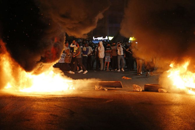 Palestinian protesters burn tires during an anti-Israel demonstration over tension in Jerusalem, near the Jewish settlement of Beit El near Ramallah, in the occupied West Bank, on May 10, 2021. ( AFP / ABBAS MOMANI)