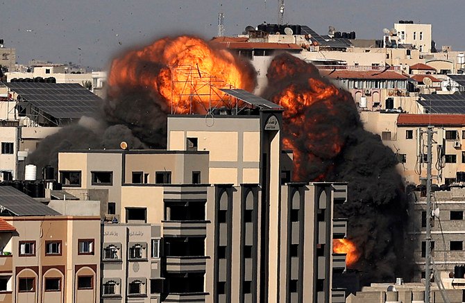 A picture shows the explosion after an Israeli strike targeted a building in Gaza City on May 14, 2021. Israel pounded Gaza and deployed extra troops to the border as Palestinians fired barrages of rockets back. (AFP)
