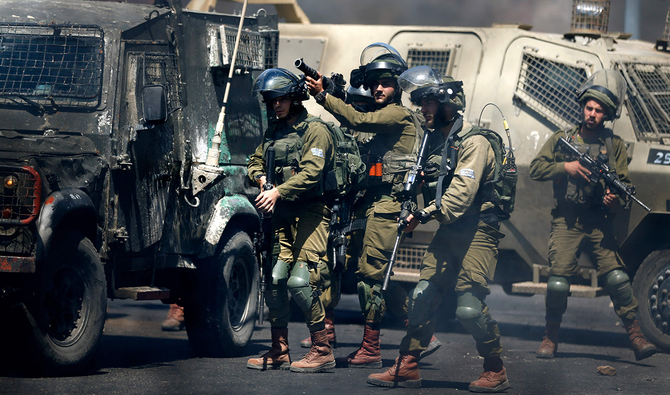 Israeli soldiers on Friday fire teargas canisters at Palestinian demonstrators near the Jewish settlement of Beit El near Ramallah in the occupied West Bank. (AFP)