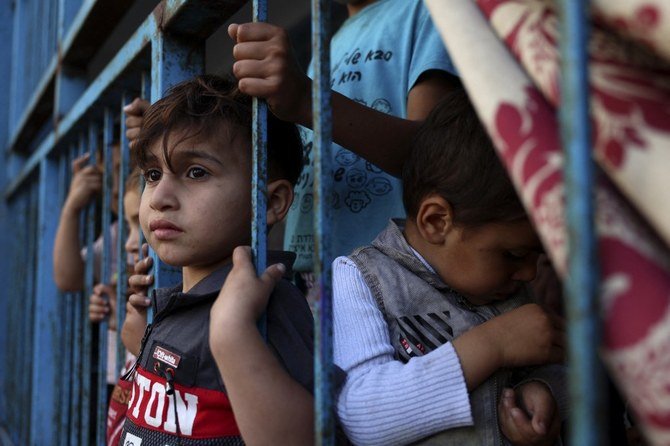 A Palestinian girl, who fled her home due to Israeli air and artillery strikes, plays at a school hosting refugees in Gaza , on May 14, 2021. (File/AFP)