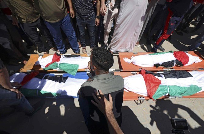 Palestinians take part in the funeral of the Abu Hatab family in Gaza City on May 15, 2021, who were killed early in an Israeli air strike on the western Gaza Strip. (AFP)