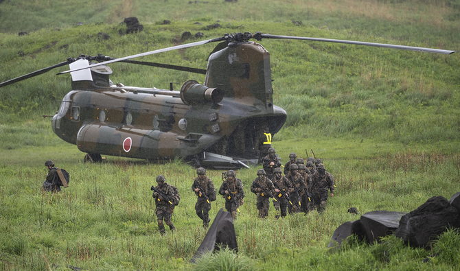 French army soldiers walk from a Chinook helicopter during a joint military drill between Japan Self-Defense Force, French army and US Marines, at the Kirishima exercise area in Ebino, southern Japan on May 15, 2021. (AP)