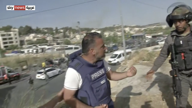 The Sky News Arabia crew filming at the scene said police assaulted correspondent Firas Lutfi, and tried to break their camera. (Screenshot)