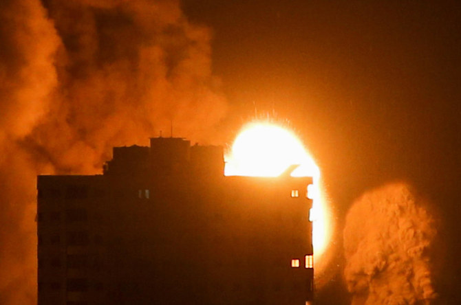 Smoke and flames rise above a building during Israeli air strikes in Gaza City at dawn on May 17, 2021. (REUTERS/Ibraheem Abu Mustafa)
