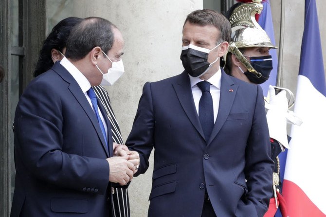 French President Emmanuel Macron watches Egyptian President Abdel Fattah el-Sissi after their talks at the Elysee Palace on Monday in Paris. (AP)