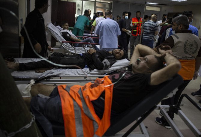 Palestinians receive treatment at Shifa Hospital from their wounds caused by Israeli airstrikes that destroyed parts of a commercial building and damaged the Health Ministry and a clinic in Gaza City. (AP)