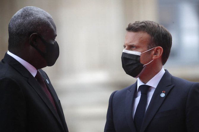 French President Emmanuel Macron welcomes Chairperson of the African Union Commission, Moussa Faki Mahamat at the summit to support Soudan on Monday in Paris. (AP)