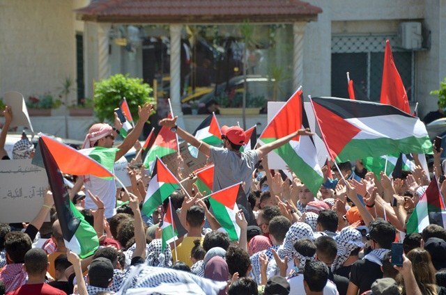 Demonstrators express solidarity with the Palestinian people in Amman, near the embassy of Israel, whose ambassador faces demands to be expelled by 90 Jordanian MPs on Monday. (Reuters)