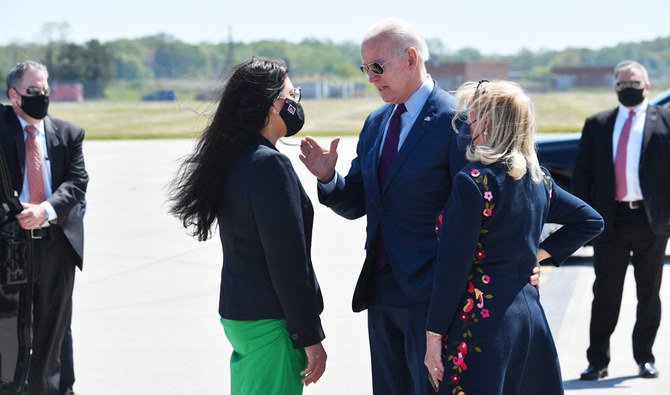 US President Joe Biden speaks with Representative Rashida Taib (D-Mich), and Representative Debbie Dingell (D-Mich)(R), as he arrives at Detroit, Metropolitan Wayne County Airport in Detroit, Michigan on May 18, 2021. (AFP)