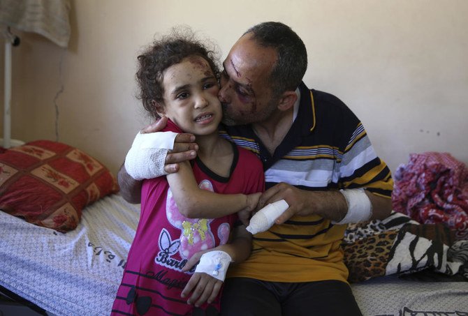 Suzy Ishkontana, 7, and her father Riad Ishkontana, 42, were the only survivors of their family after an Israeli airstrike destroyed one of the buildings they lived in in Gaza City early Sunday, killing her mother and four siblings. (AP)