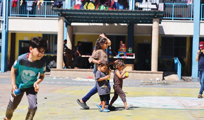 Displaced children in Gaza City play at a school run by the UN Relief and Works Agency for Palestinian Refugees, where many families have sought refuge. (AFP)