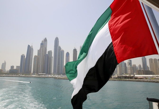 A UAE flag flies over a boat at Dubai Marina in the UAE where foreigners starting a company will no longer need an Emirati shareholder. (Reuters)