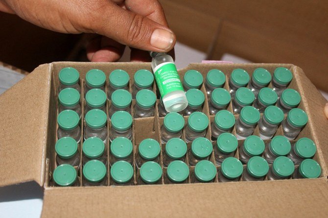 An employee shows vials of the AstraZeneca/COVISHIELD vaccine (a version of the vaccine produced in India) upon the arrival of the first shipment at the airport of Aden, on March 31, 2021. (File/AFP)