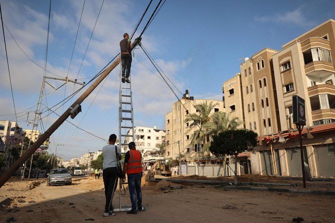 Palestinians gather at the site of Israeli air strikes in Jabalia in the northern Gaza Strip, on May 20, 2021. (AFP)