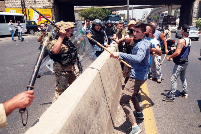 Activists protesting against ‘an organized vote for Bashar Assad’ scuffle on Monday with Lebanese soldiers in the town of Zouk Mosbeh, north of Beirut. (AP)