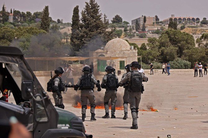 Israeli security forces and Palestinian Muslim worshipers clash in Jerusalem’s Al-Aqsa mosque compound on May 21, 2021. (AFP)