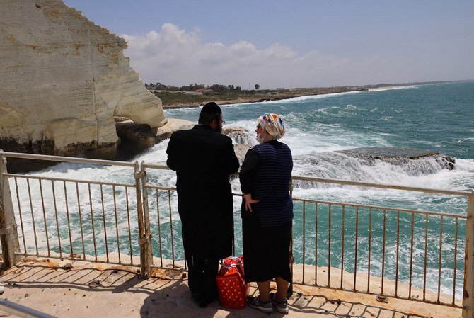 A Jewish couple visit the grottoes at the Israeli-Lebanese border in Rosh Hanikra. (File/AFP)