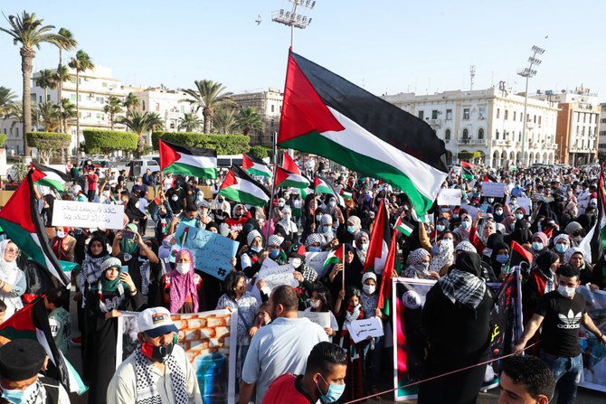 Libyans rally at the Martyrs Square in Tripoli in support of Palestinians on May 21, 2021. (Photo by Mahmud Turkia / AFP)