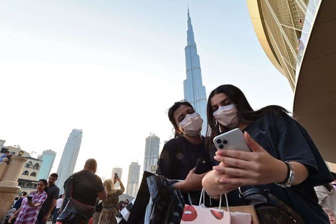 Women wearing protective masks pose for a 