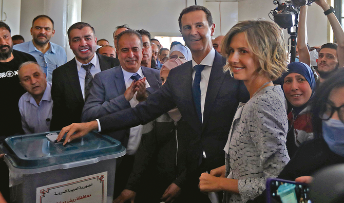 Syria’s President Bashar Assad and his wife Asma on Wednesday cast their votes at a polling station in Douma during the country’s presidential elections. (AFP)