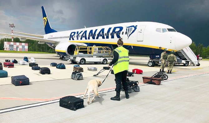 Security use a dog to check the luggage of passengers on the Ryanair jet that carried opposition figure Raman Pratasevich, traveling from Athens to Vilnius, Lithuania. (AP file photo)