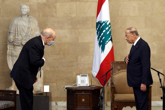 French Foreign Minister Jean-Yves Le Drian, left, and Lebanese President Michel Aoun, greet each other at the Presidential Palace in Baabda. (AP)