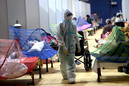 A health worker walks inside the Commonwealth Games stadium temporarily converted into a Covid-19 Coronavirus care centre in New Delhi on May 5, 2021. (AFP)