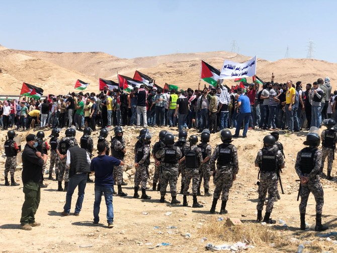 Demonstrators hold Palestinian flags during a protest to express solidarity with the Palestinian people, in Karameh, Jordan valley. (Reuters)